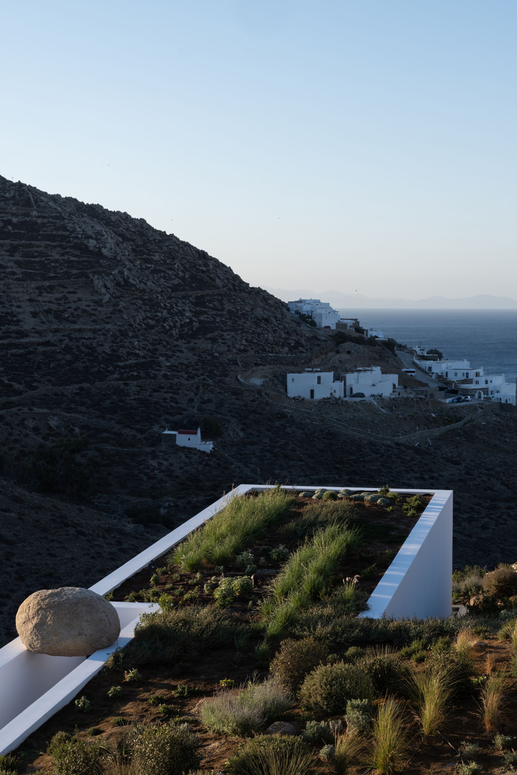 rooftop garden on mykonos villa with grasses and view of coastline