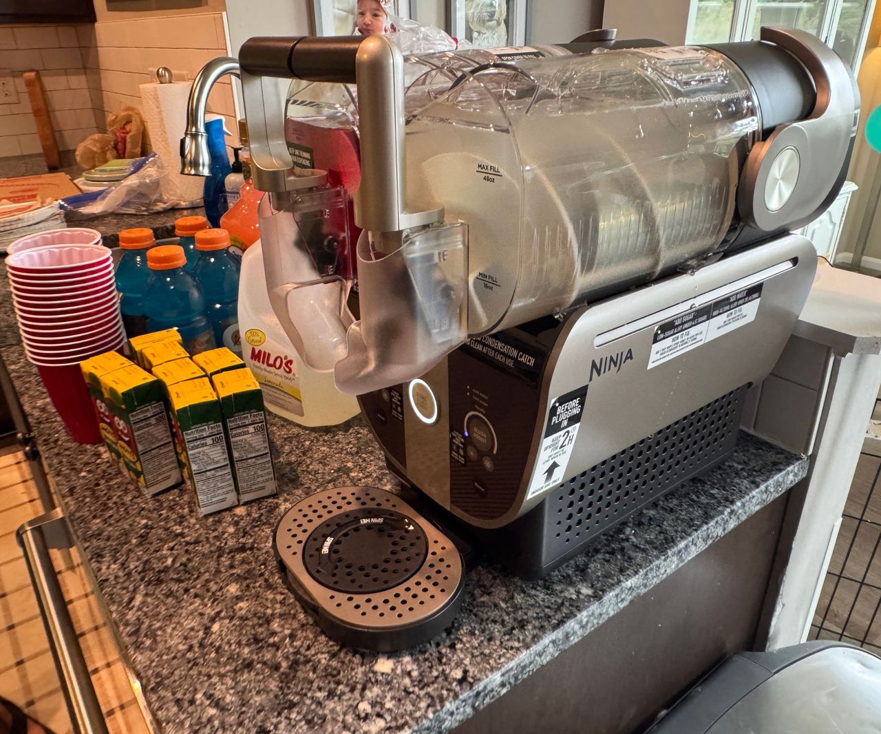 A Ninja Slushi Twist on a kitchen counter beside a sink