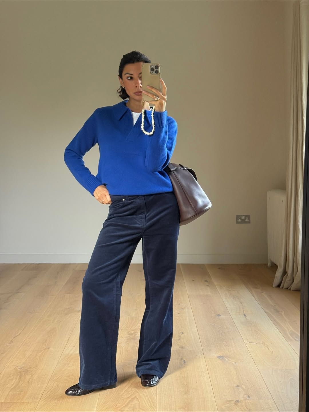 Influencer Marianne Smythn wearing corduroy trousers and a henley jumper.