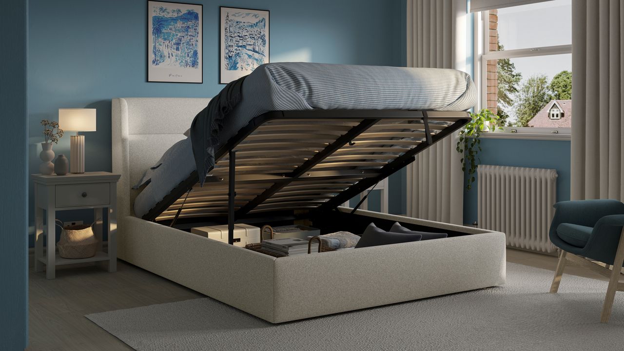 An ottoman bed in a blue bedroom with the mattress lifted