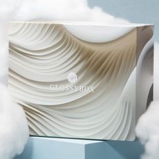 Glossybox January box on a pastel blue background with clouds