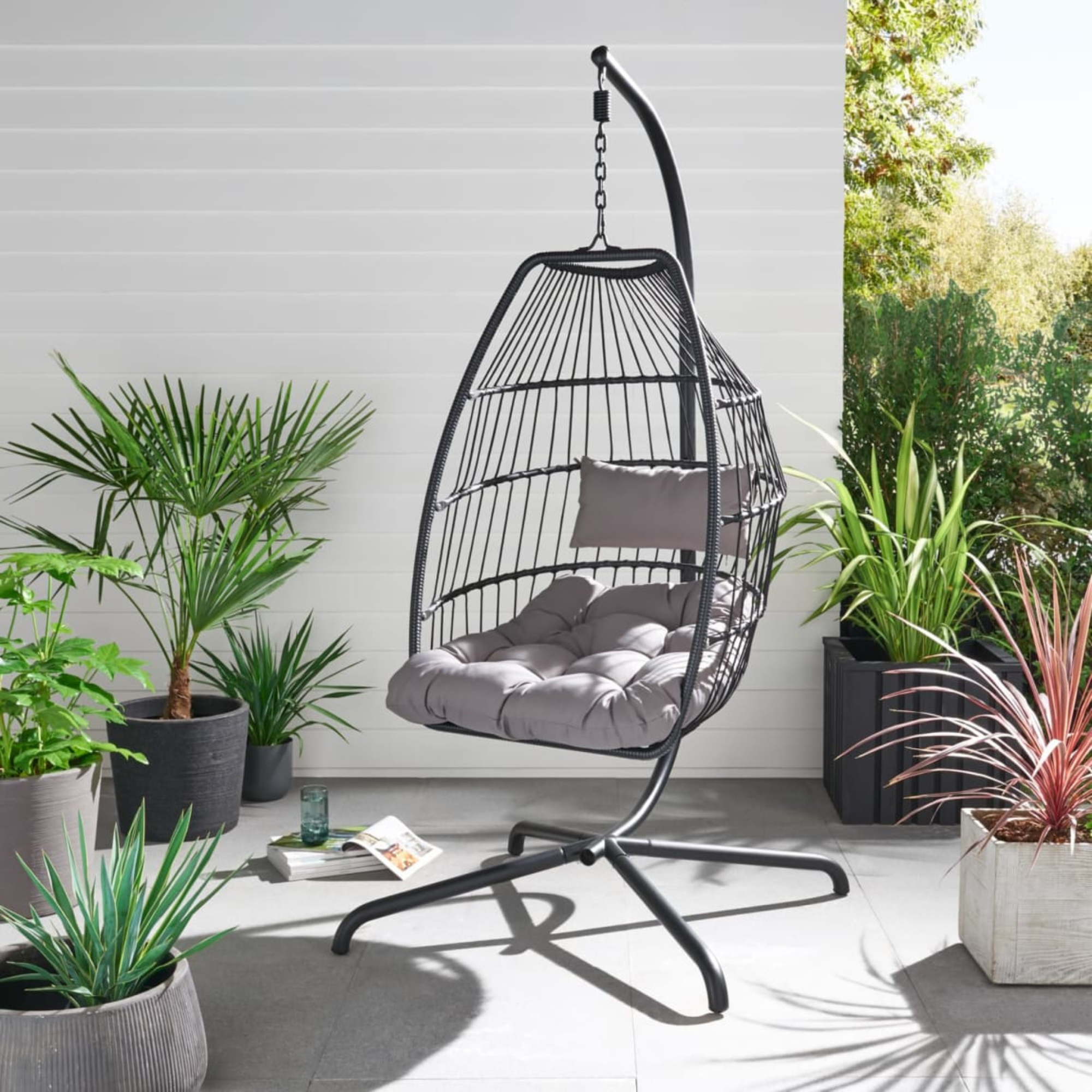 B&amp;amp;M Santorini egg chair in black on a patio.