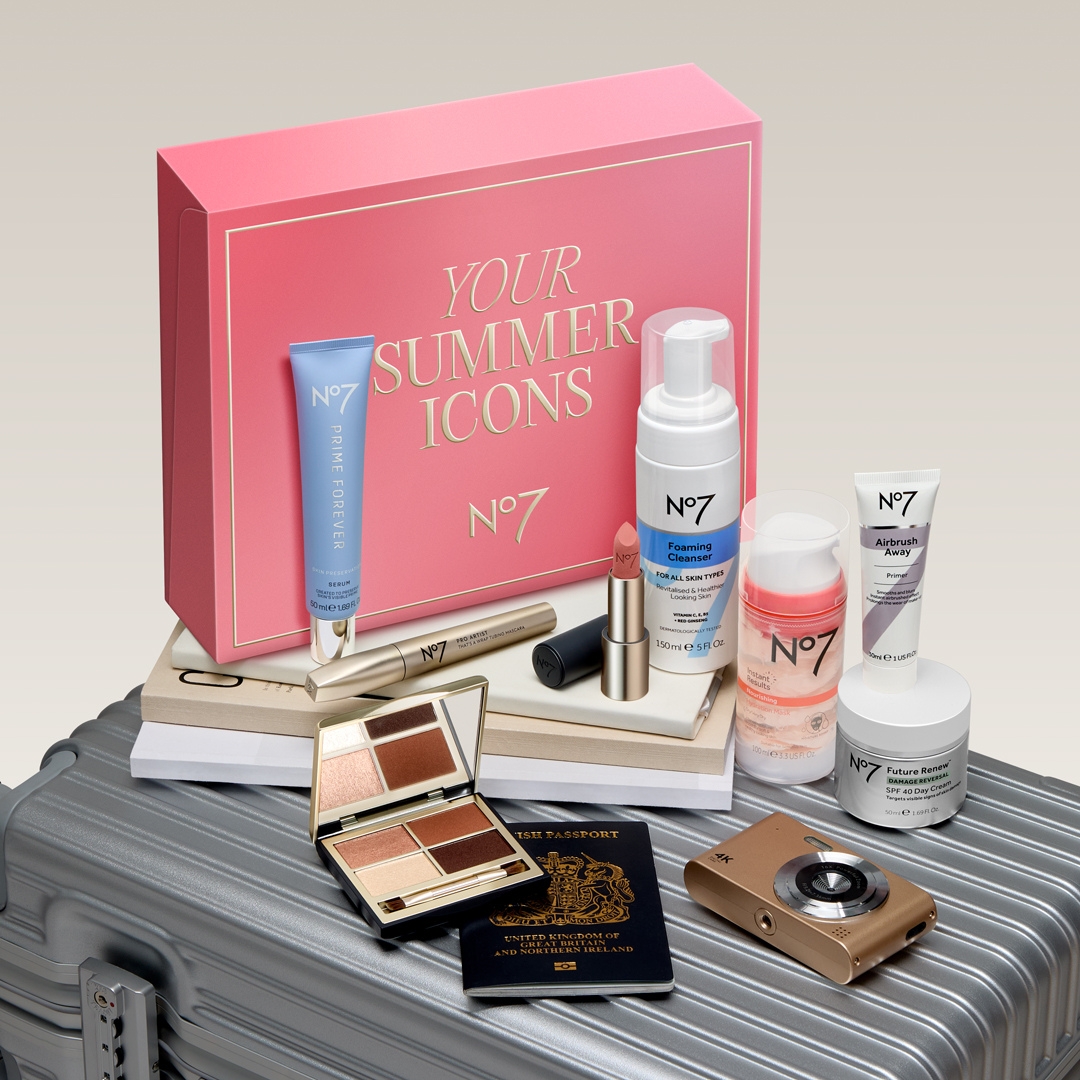 No7 Your Summer Icons Beauty Box on top of a grey suitcase with its contents at the front