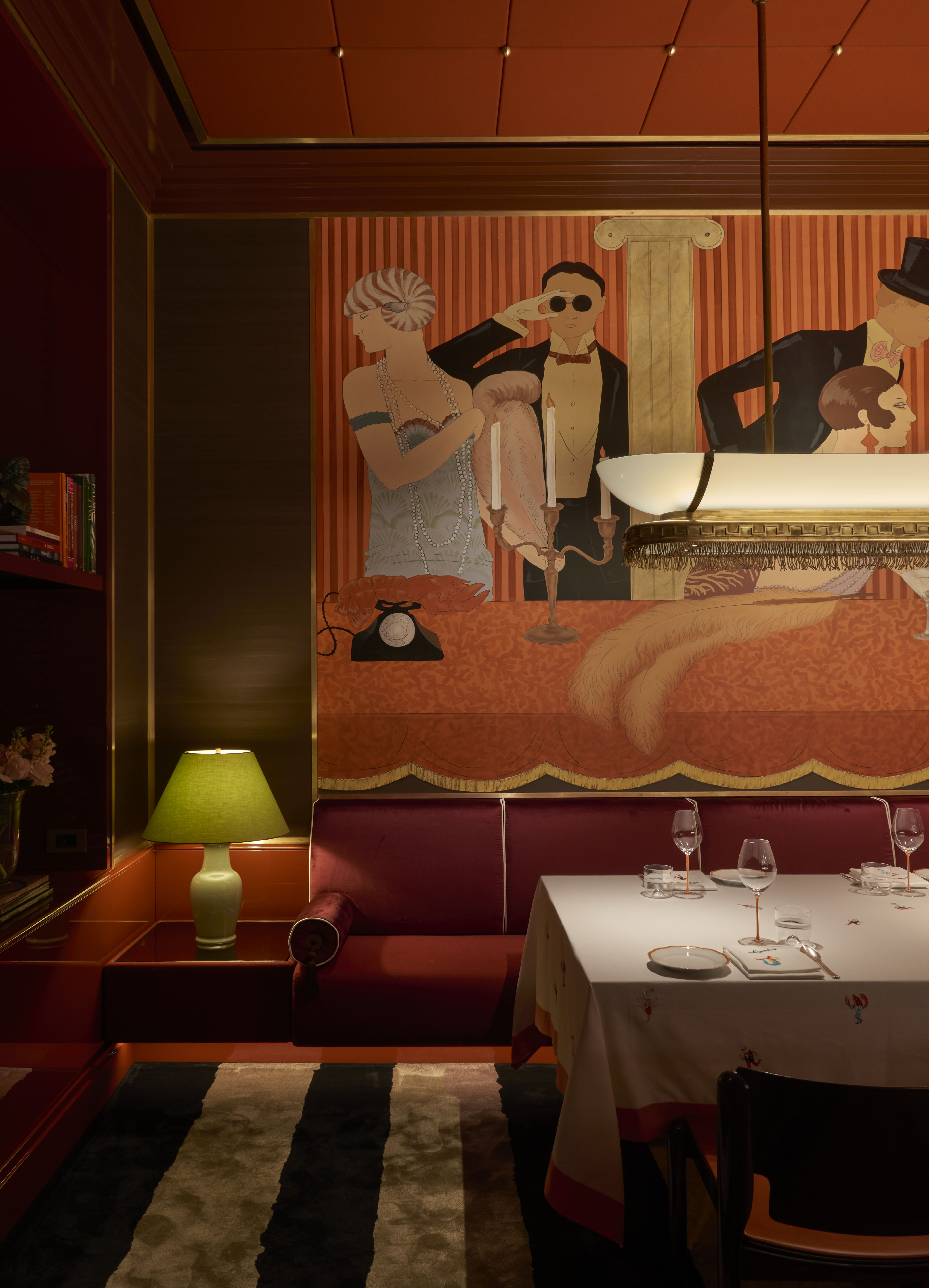 a small restaurant with glamorous red interiors and moody lighting