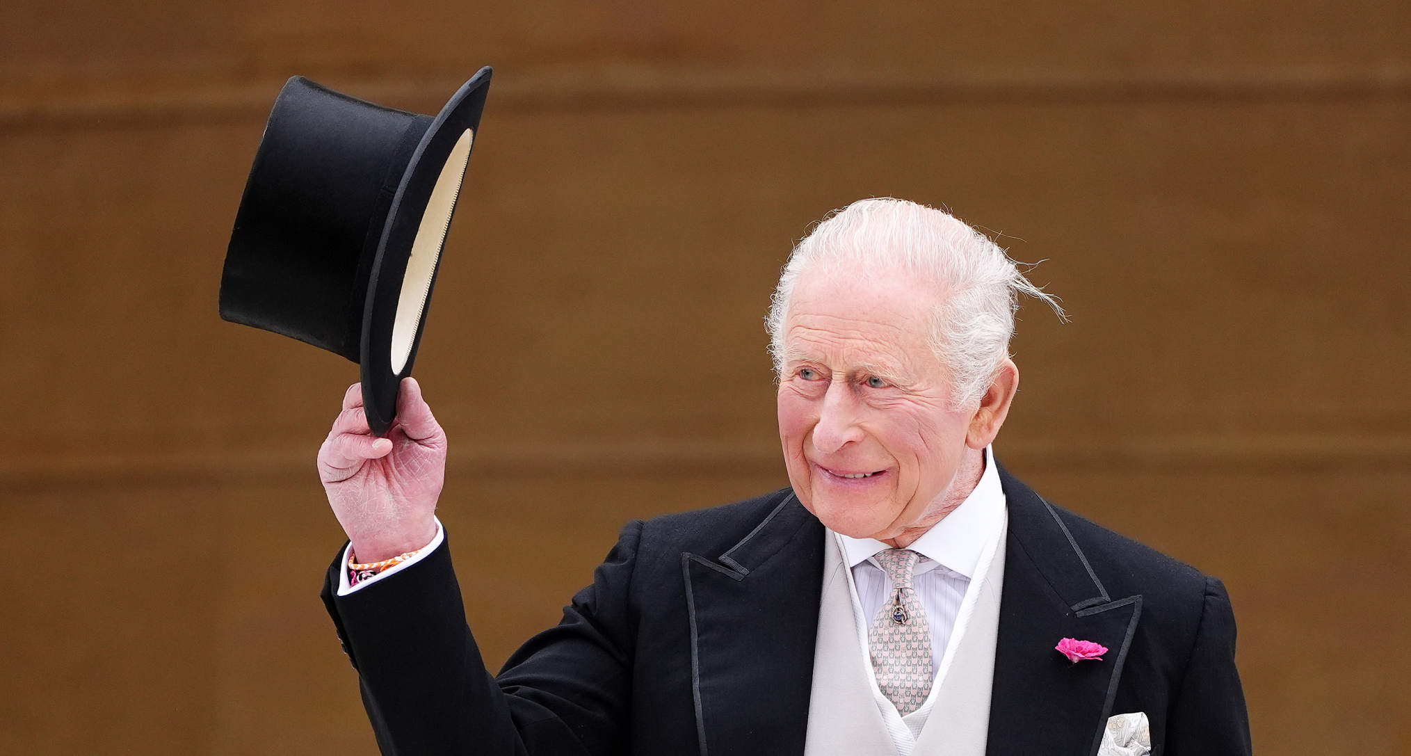 King Charles tipping his top hat