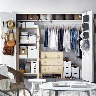 wardrobe with white wall wooden drawer and hangers