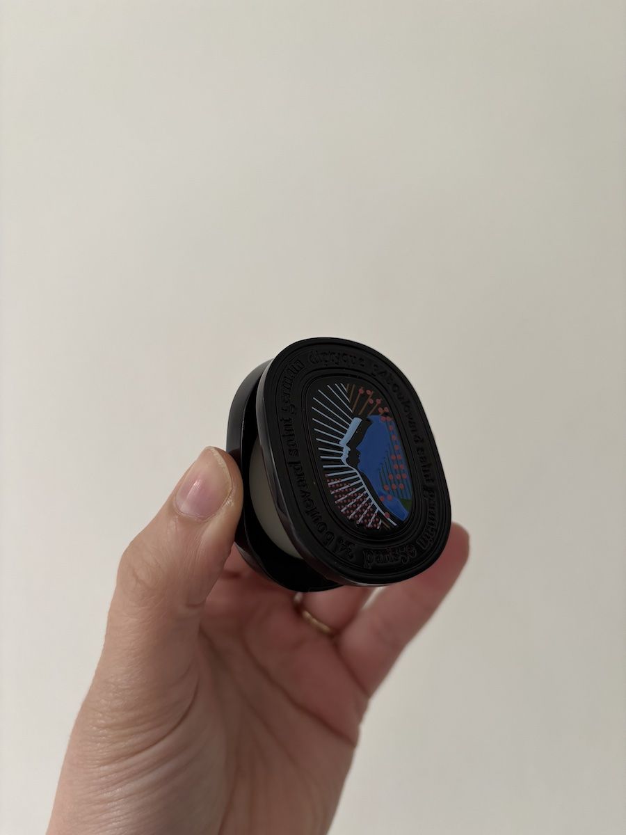 Mica Ricketts holding Diptyque Orphéon Refillable Solid Perfume