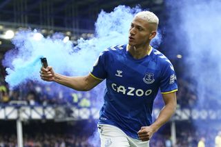 Richarlison picks up a flare after scoring the game's only goal