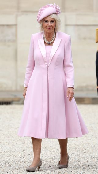Queen Camilla in a pastel pink dress