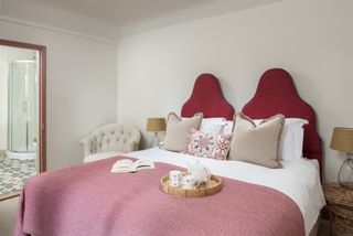 pink bedroom with statement headboards
