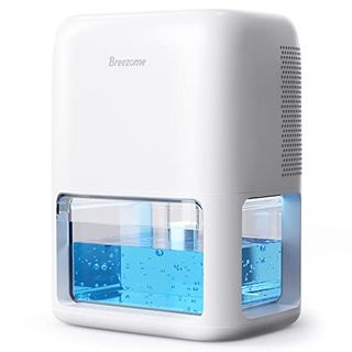 A white Breezome 60 Oz Dehumidifier with clear tank filled with blue water