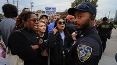 Protesters argue with local police outside an ICE detention center in Broadview, Illinois.