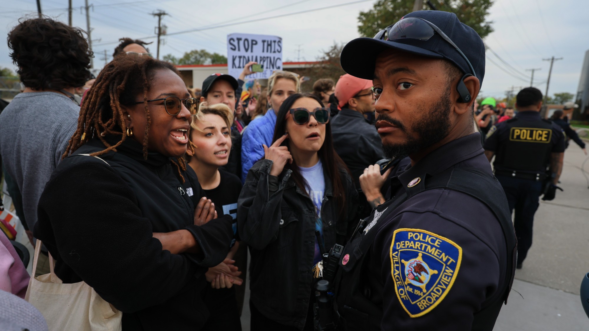 Protesters argue with local police outside an ICE detention center in Broadview, Illinois.