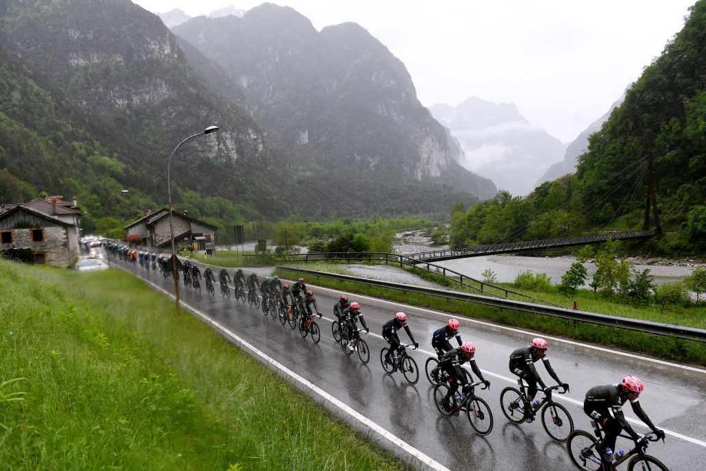 CORTINA DAMPEZZO ITALY MAY 24 Hugh Carthy of United Kingdom Julius van den Berg of Belgium Alberto Bettiol of Italy Jonathan Klever Caicedo Cepeda of Ecuador Simon Carr of United Kingdom Ruben Guerreiro of Portugal Jens Keukeleire of Belgium Tejay Van Garderen of United States and Team EF Education Nippo the peloton passing through Agordo 611m mountain landscape during the 104th Giro dItalia 2021 Stage 16 a 153km stage shortened due to bad weather conditions from Sacile to Cortina dAmpezzo 1210m Rain Fog girodiitalia Giro on May 24 2021 in Cortina dAmpezzo Italy Photo by Tim de WaeleGetty Images