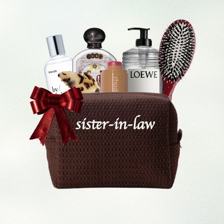 a makeup bag for your sister in law filled with beauty gifts on a green and blue background