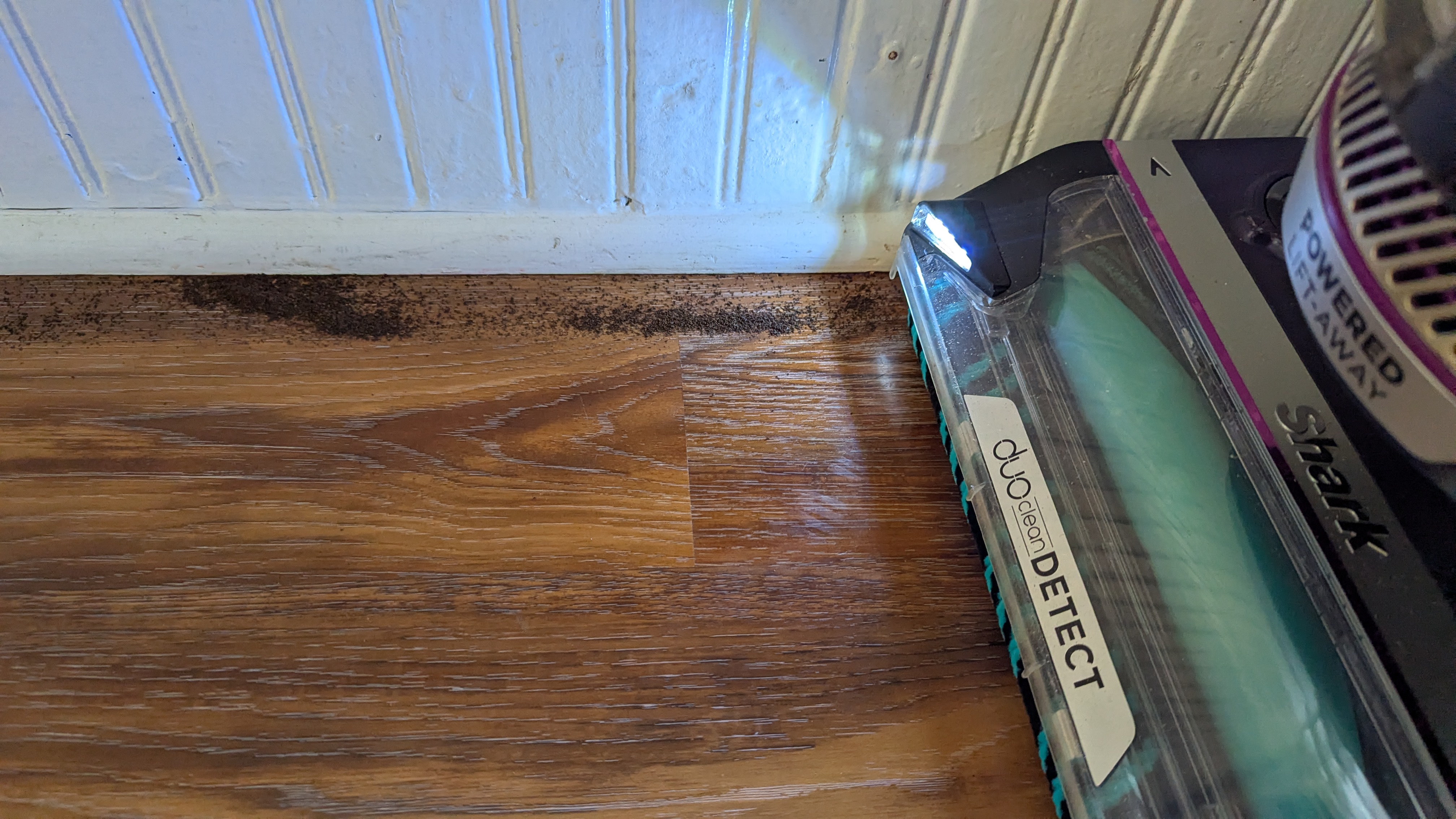 Shark PowerDetect Upright vacuum performing suction tests on hard floor
