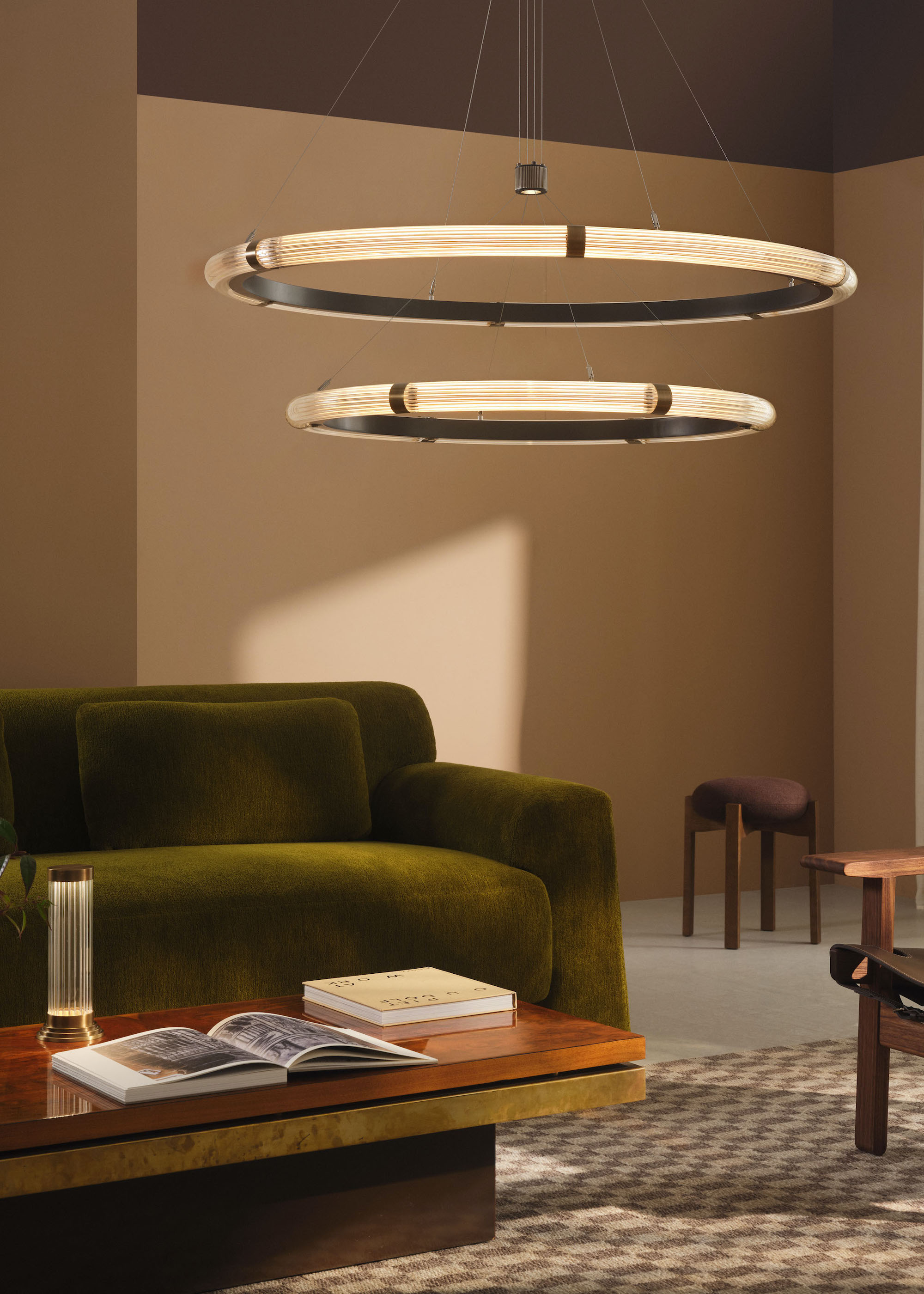 green sofa with two circular light pendants above