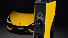 A Sonos Faber Cremonese Ex3me speaker in yellow next to a yellow Lamborghini