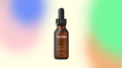 An image of the Medik8 Super C30 serum on a colorful background