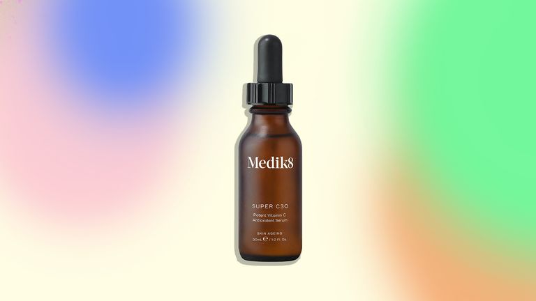 An image of the Medik8 Super C30 serum on a colorful background