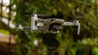 The DJI Mini 2 drone in full flight in a garden during testing