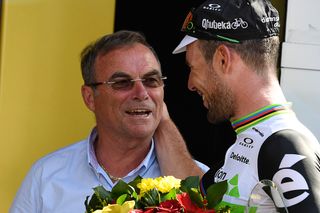 Mark Cavendish greets Bernard Hinault on the stage 6 podium after surpassing the Frenchman's number of Tour de France stage wins.