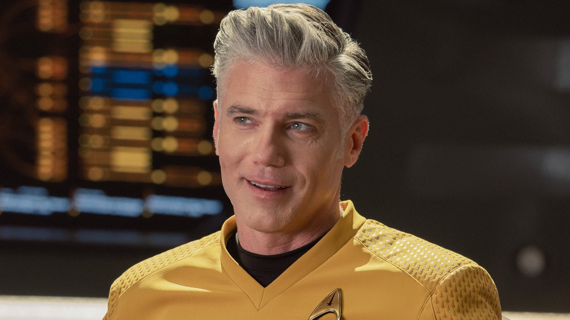 Pike smiling in his Captain's chair. 