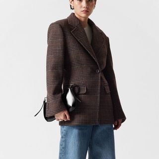 flat lay image of woman wearing brown tweed jacket 