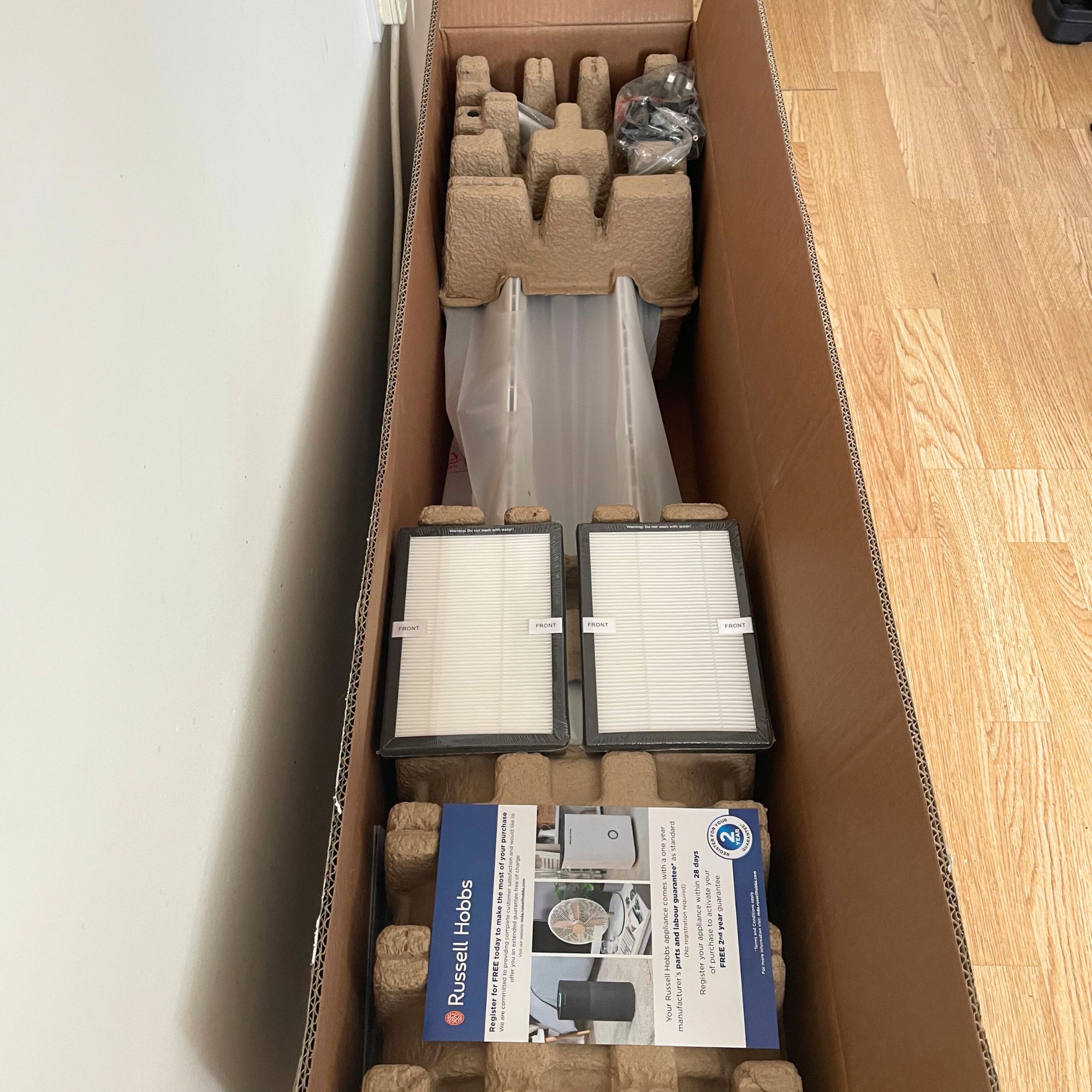 Open box of the Russell Hobbs RHBLDL12 Bladeless Tower Fan showing the contents inside
