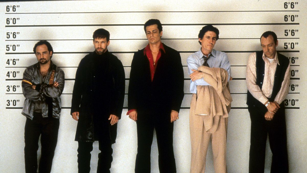 The lead cast of The Usual Suspects movie, in a police line-up room