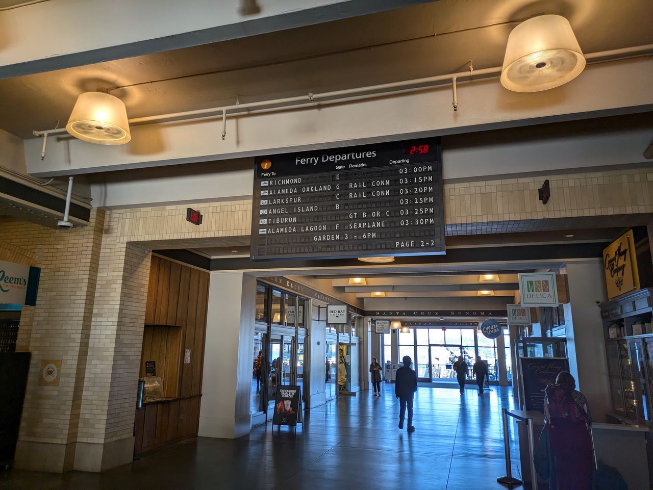 A ferry departure board inside the Ferry Building shot by the Pixel 8a