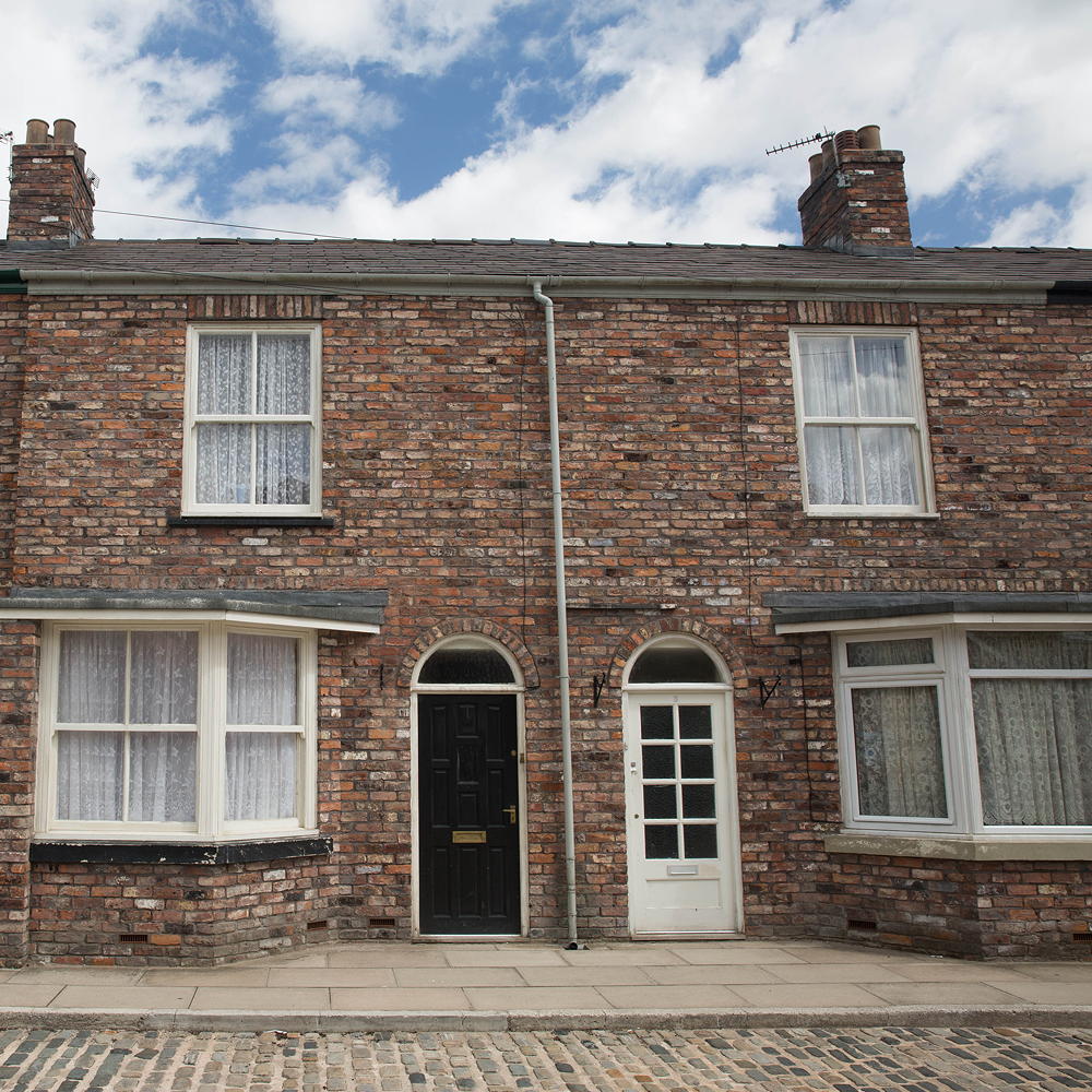 house with brick wall and white windows