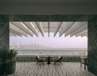 The Ned Doha by David Chipperfield showing terrace with two chairs looking out
