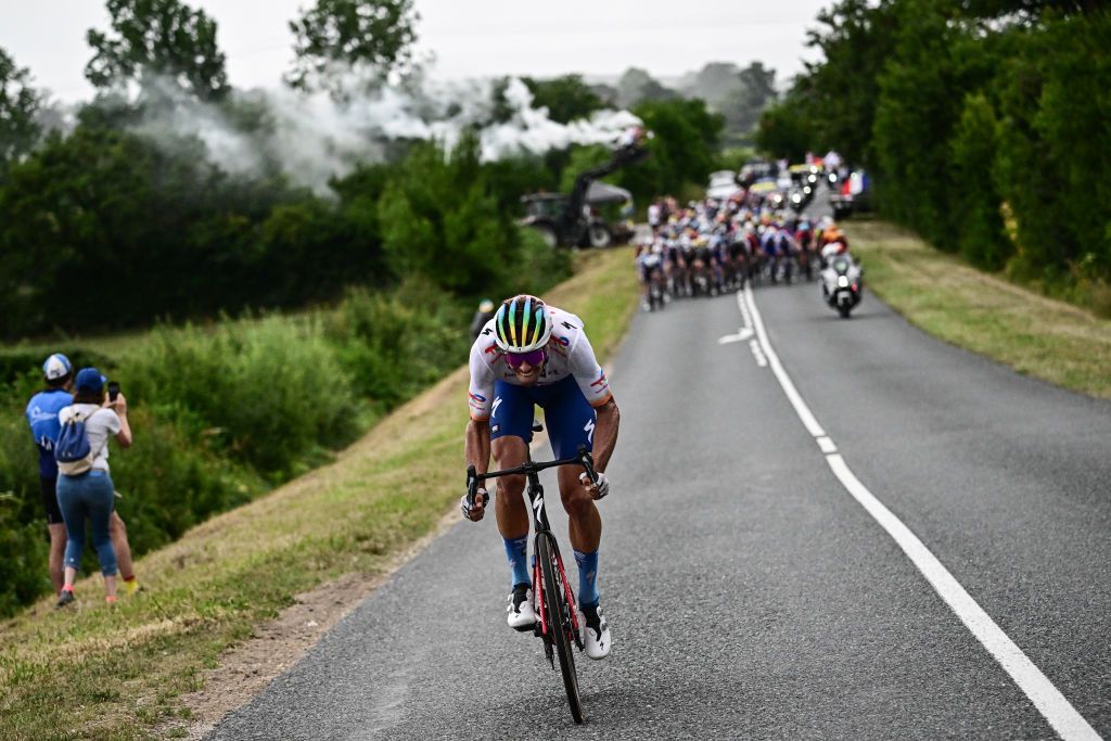 TotalEnergies' Italian rider Daniel Oss cycles in a lone breakaway ahead of the pack of riders during the 11th stage of the 110th edition of the Tour de France cycling race, 180 km between Clermont-Ferrand and Moulins, in central France, on July 12, 2023. (Photo by Marco BERTORELLO / AFP)