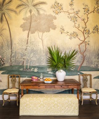 breakfast room with tree mural and upholstered bench and chairs with old wooden table