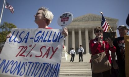 Protesters gather outside the Supreme Court, where justices heard arguments Tuesday on the constitutionality of the individual mandate, which requires nearly all Americans to obtain health in