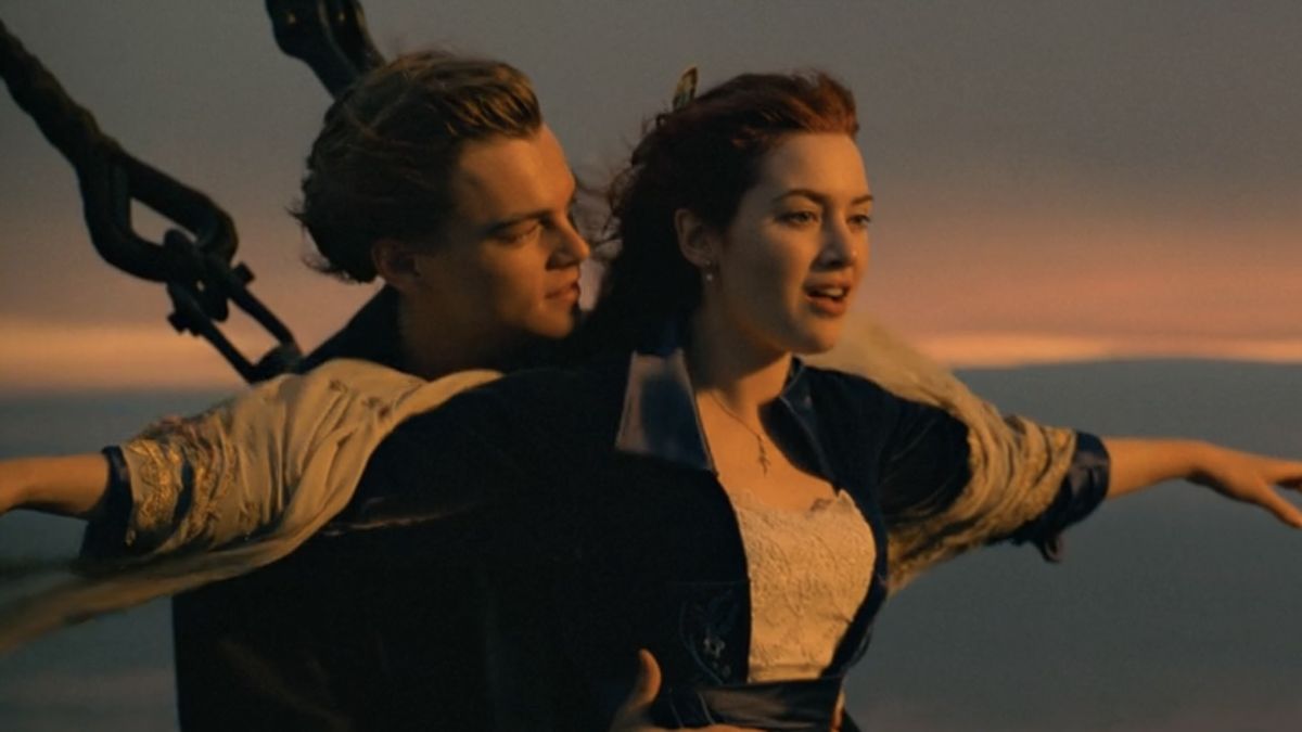 Jack standing behind Rose with their arms out in Titanic