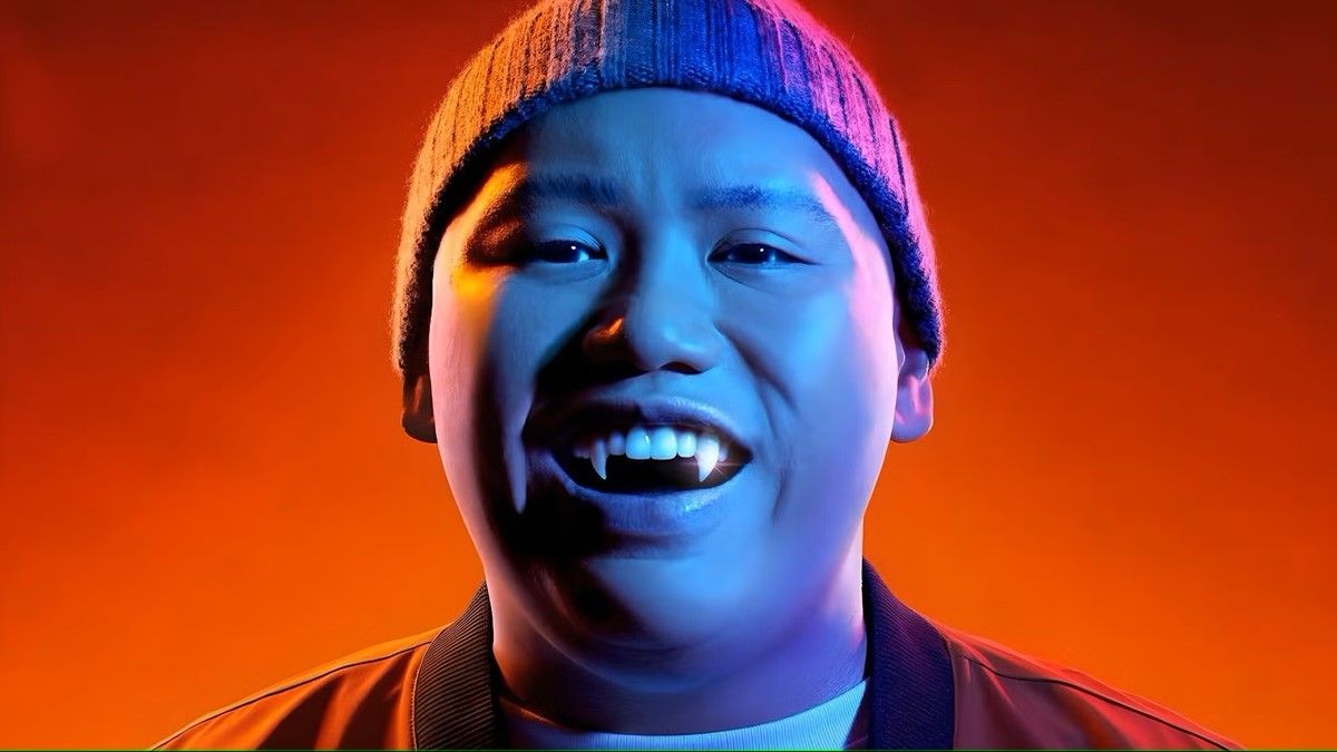 Actor Jacob Batalon smiles and shows off his fangs in &#039;Reginald the Vampire&#039; season 2 on the Syfy channel. 