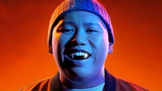 Actor Jacob Batalon smiles and shows off his fangs in 'Reginald the Vampire' season 2 on the Syfy channel. 