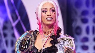 Mercedes Mone with the AEW TBS Championship and NJPW Strong Women's Championship over her shoulders