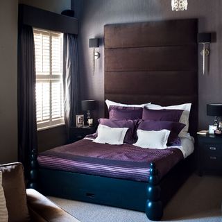 bedroom with purple bed and brown alnd headboard
