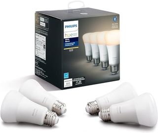 Four white Edison screw in lightbulbs in front of a Phillips branded cardboard box