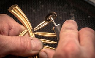 A gold leaf being polished to make shiny