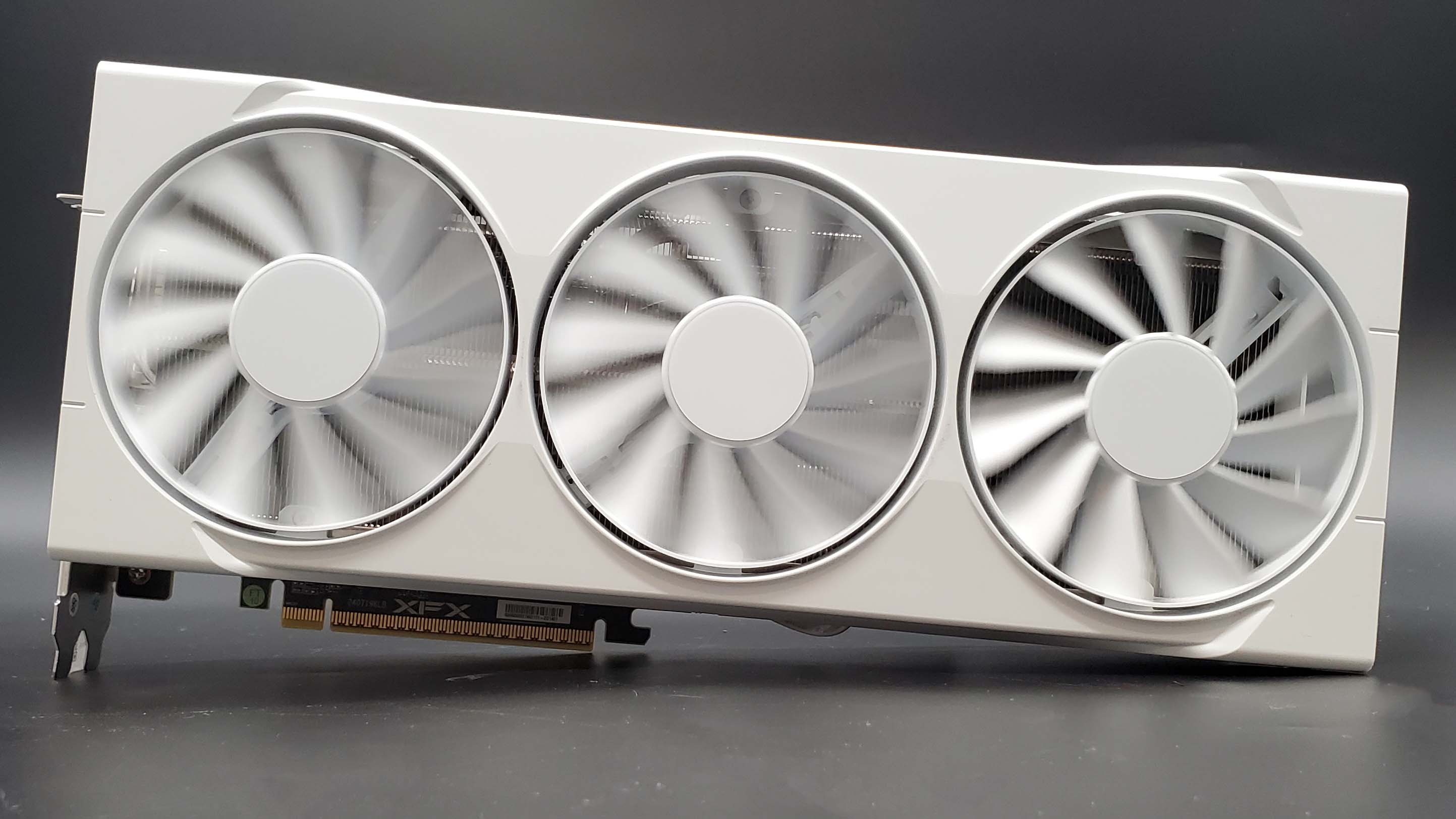 XFX Swift Radeon RX 9070 OC graphics card on a grey background with a gradient