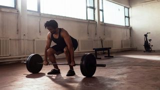 What is a deload week: man performing deadlift