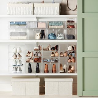 Stacked clear acrylic storage boxes with shoes and accessories