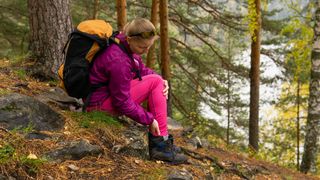 Woman with injured ankle in the woods