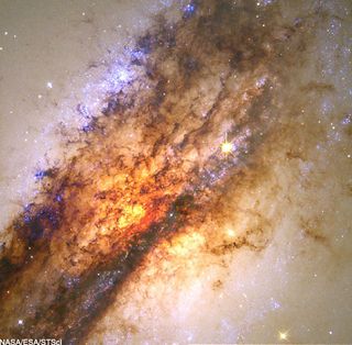Black hole hidden in the center of a galaxy feeding on a smaller galaxy.