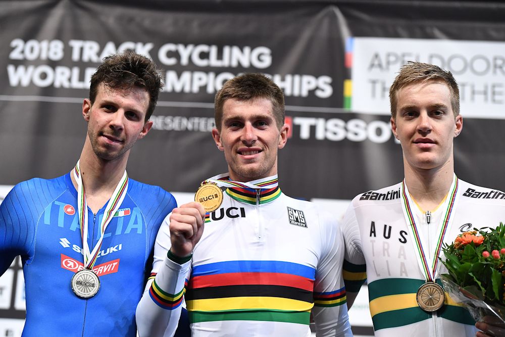 Silver medallist Italy's Michele Scartezzini, gold medallist Belarus' Yauheni Karaliok, and bronze medallist Belarus' Yauheni Karaliok pose on the podium after the men's Scratch final