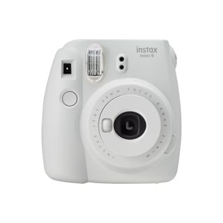 white polaroid camera by fujifilm